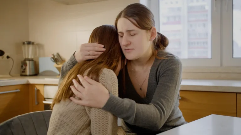 mom hugging and supporting teen with depression